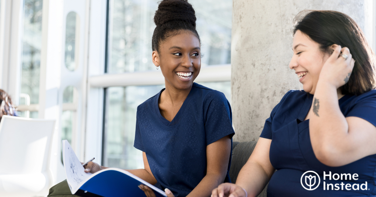 2 women study together to meet the requirements for being a professional caregiver.