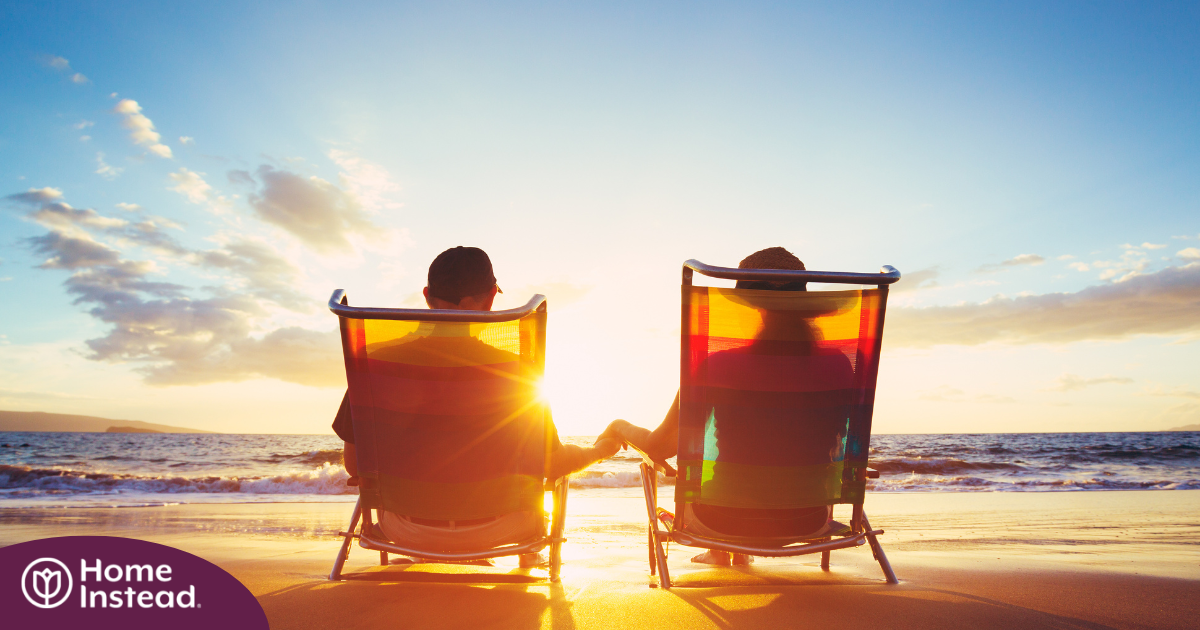 Caregiver travel hacks can help couples like this one on the beach enjoy their vacation.