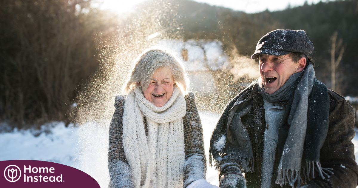 As a result of good winter safety practices, an elderly couple can enjoy time outside in the snow.