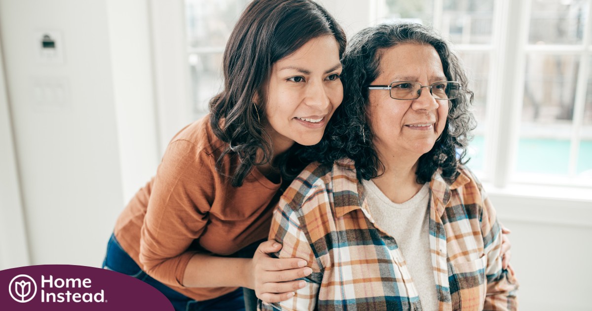 A woman hugs her older mother, representing compassionate senior care