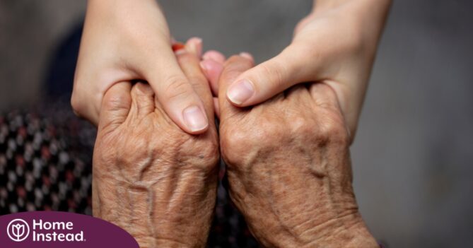 Younger hands hold older ones, representing the care and compassion of caregiving and how caregivers can help, even in ways like implementing stroke prevention strategies.